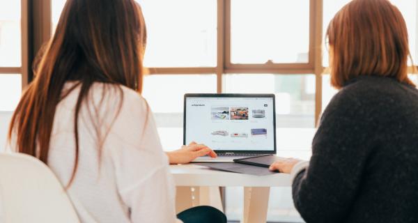 Two people in front of computer